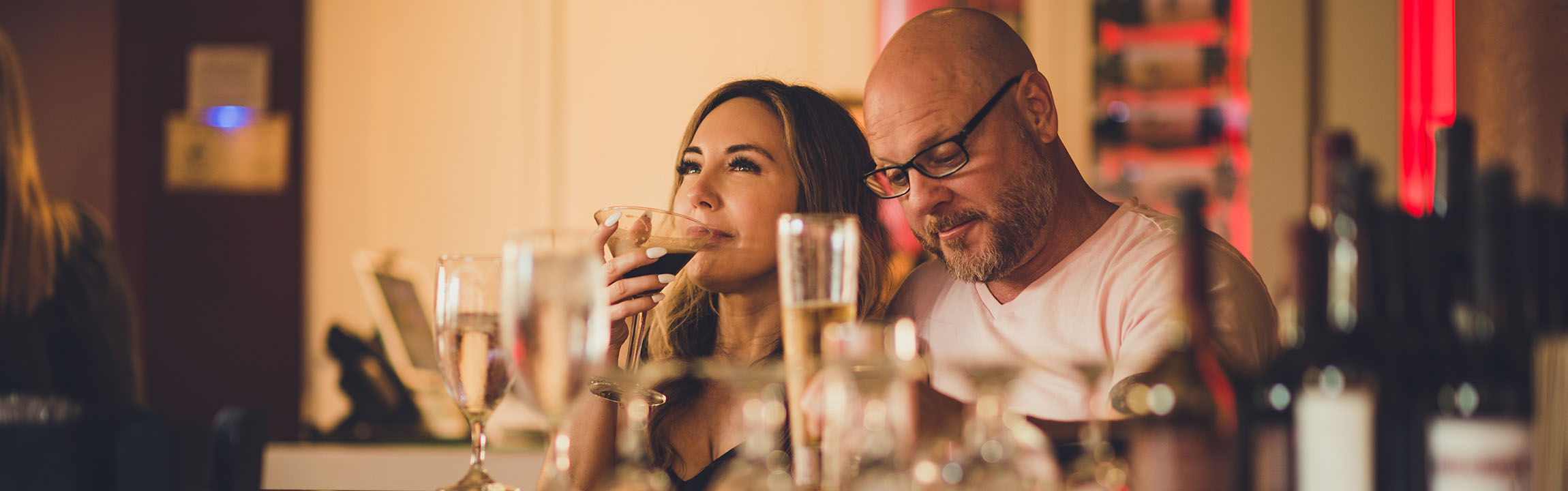 Two guests enjoy cocktails at the bar at Martini Modern Italian.